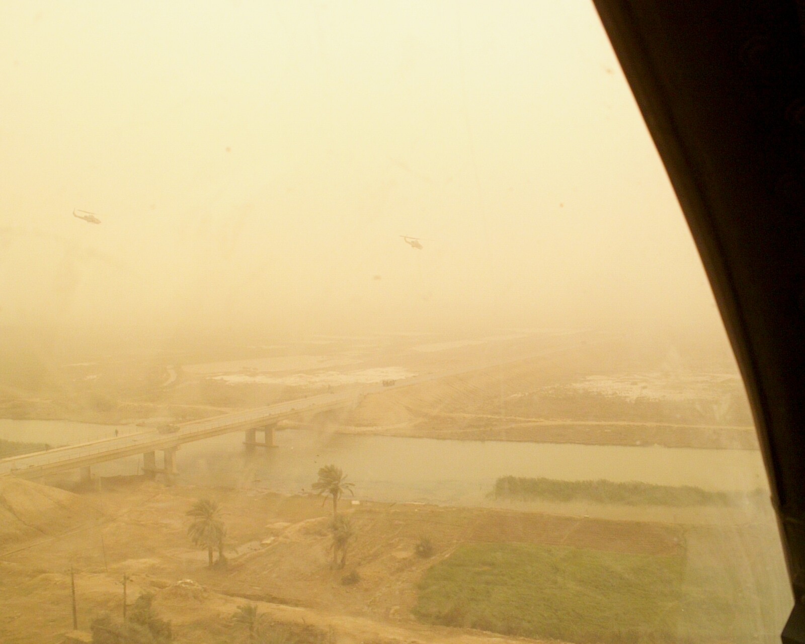 Flying north along Highway 7 into the attack, 26 March 2003. BT and Spock’s aircraft are just visible above the highway and two friendly armored vehicles are underneath them. Visibility got worse before we called it quits. pg. 175