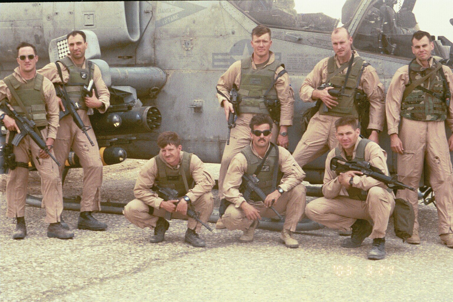 Taken at Camden Yards FARP. From left to right standing: Weasel, IKE, JoJo, Fuse, Spock. From left to right kneeling: Gash, Shoe, BT. Hanging from the Cobra’s wing in the back are three hellfire missiles and a full seven-shot rocket pod. pg 184