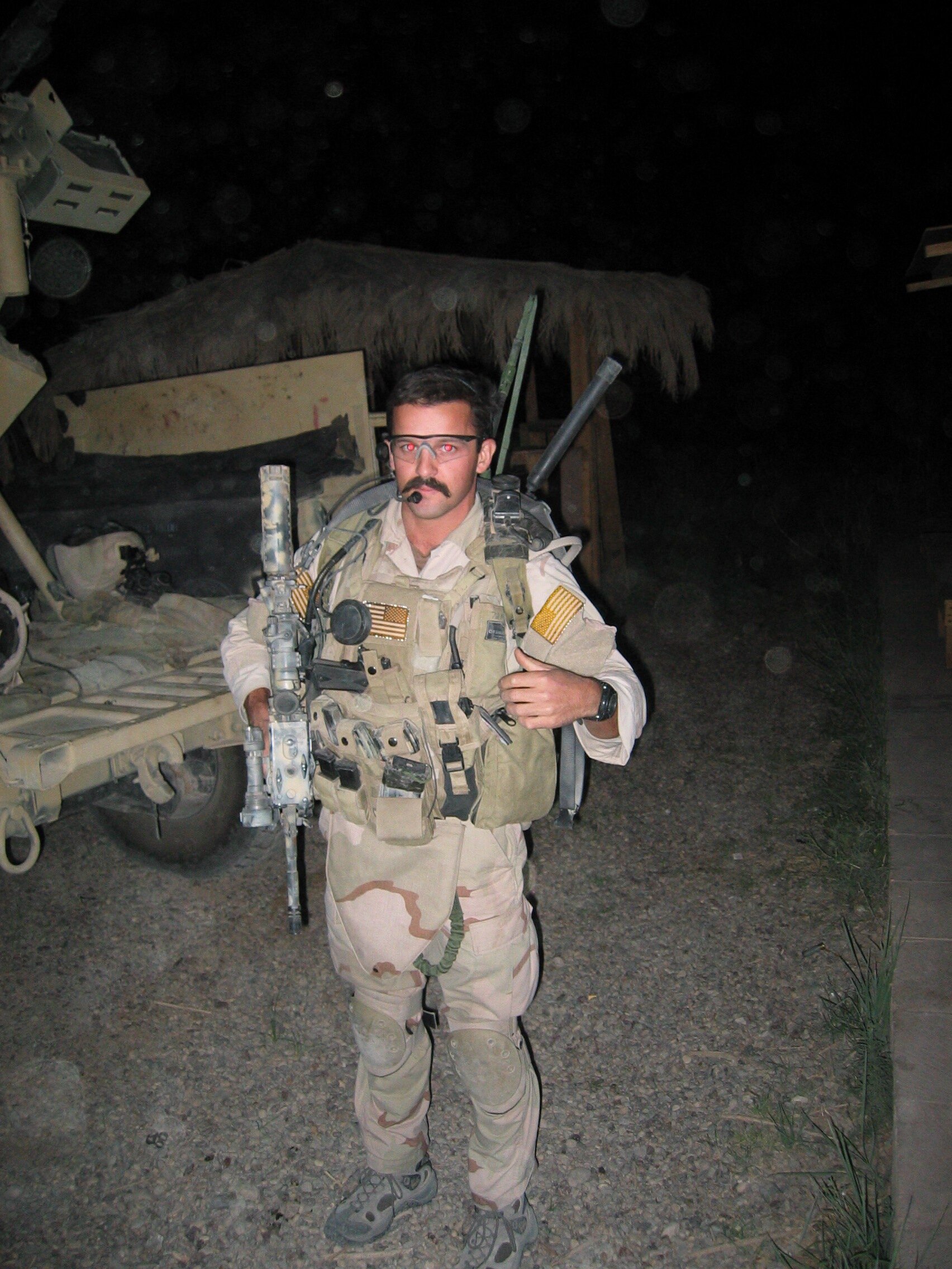 Prepping for a mission with MCSOCOM Det One, Baghdad 2004. Armed with an M-4 and a .45cal Kimber, the radio on my back was my most lethal weapon. pg 289